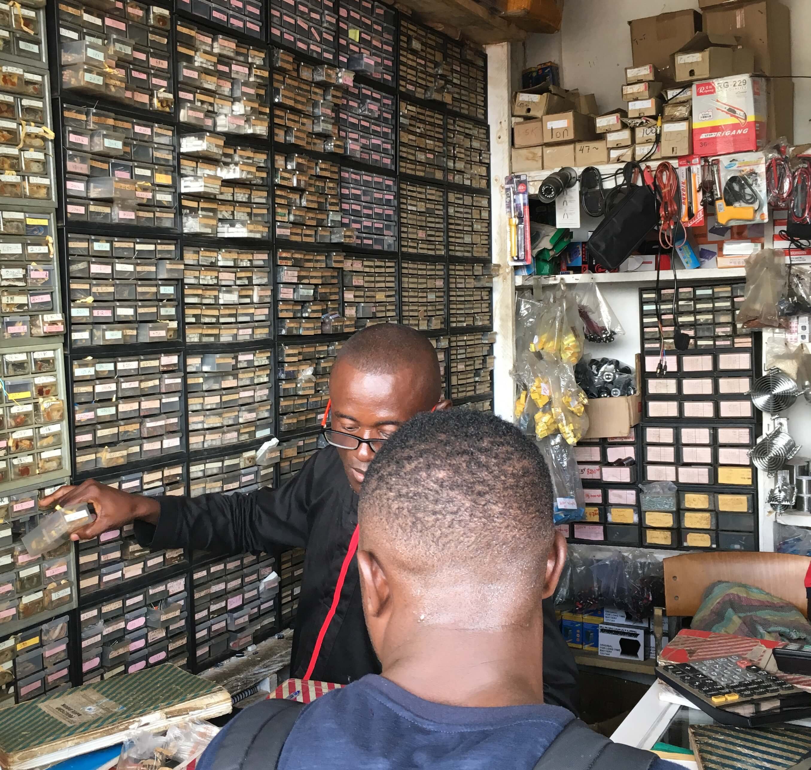 Electronics vendor serving a client in Kumasi